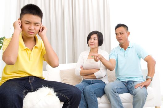 people, misbehavior, family and relations concept - upset or feeling guilty boy and parents at home