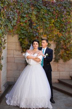 The groom put his hands on the bride's shoulders