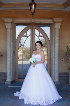 Bride with bouquet on retro door background