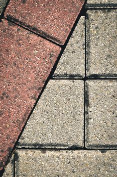 mosaic detail of old concrete pavement red and gray