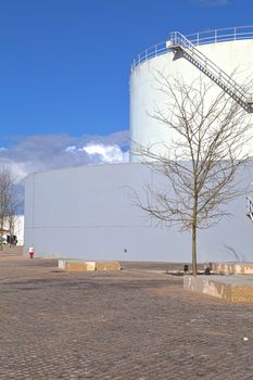 White tanks in tank farm with iron staircase 