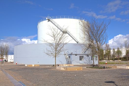 White tanks in tank farm with iron staircase 