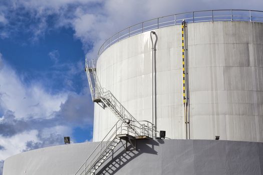 White tanks in tank farm with iron staircase 