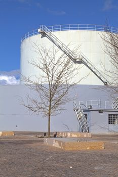 White tanks in tank farm with iron staircase 