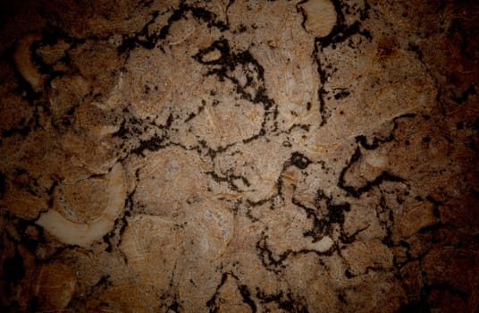 Vignetted stone wall background with lots of texture