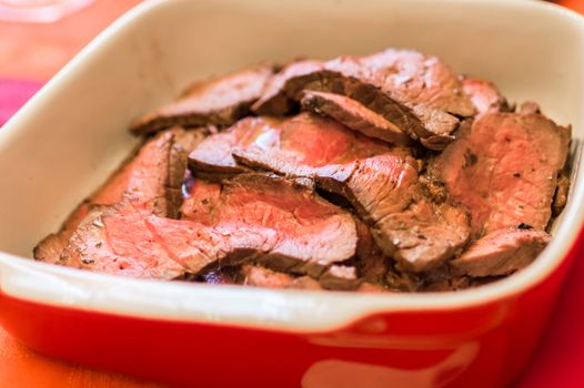 Close up raw chunks of meat in the red pan