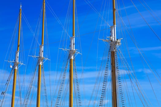 Yacht mast against blue summer sky