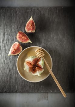 Fresh fig with honey on the plate