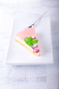 Piece of raspberry yogurt cake and raspberry sauce