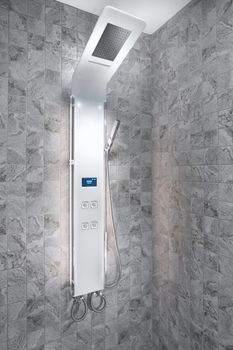 close up view of smart electronic shower panel in tiled room