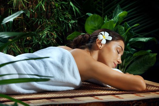 portrait of young beautiful woman relaxing  in spa environment