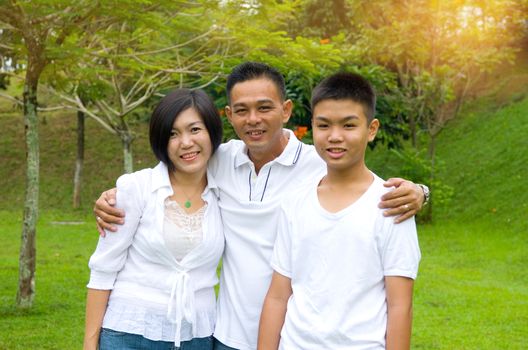 Chinese Family Relaxing In Park Together