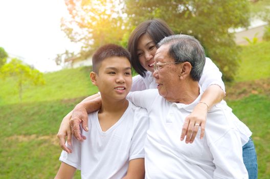 Portrait Of Multi-Generation Chinese Family Relaxing at outdoor Park 