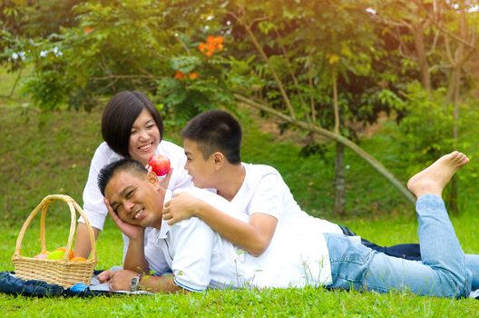 Asian Chinese Family Relaxing at outdoor park 