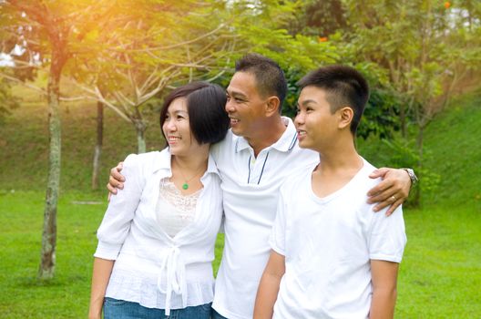 Chinese Family Relaxing In Park Together