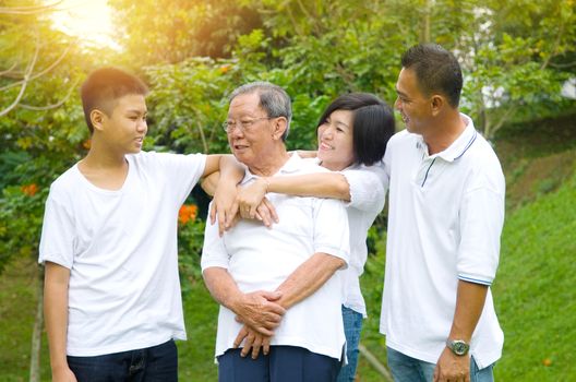 Portrait Of Asian three Generation Chinese Family Relaxing at outdoor park 