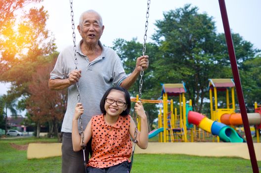 Asian Grandfather posing with grandchildren