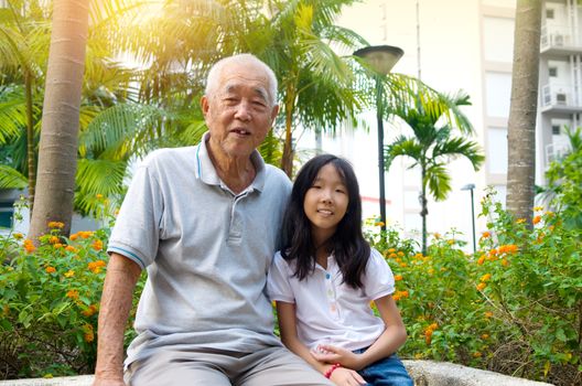 outdoor portrait of a senior man with his granddaughter