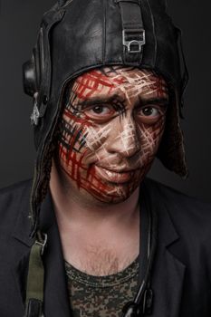 Portrait of Brutal Man with Creative Military Style Camouflage. Face Paint.  Close up on black background