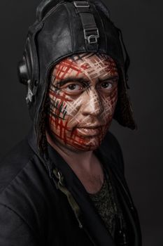 Portrait of Brutal Man with Creative Military Style Camouflage. Face Paint.  Close up on black background