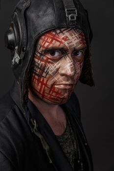 Portrait of Brutal Man with Creative Military Style Camouflage. Face Paint.  Close up on black background