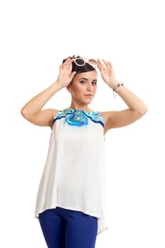 the young woman in sunglasses and in convenient clothes on a white background