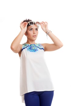 the young woman in sunglasses and in convenient clothes on a white background