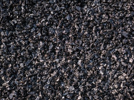 Close up asphalt road repair. Repair pavement and laying new asphalt patching method outdoors.