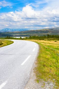 Road in Norway. Summer landscape with blue sky and mountains