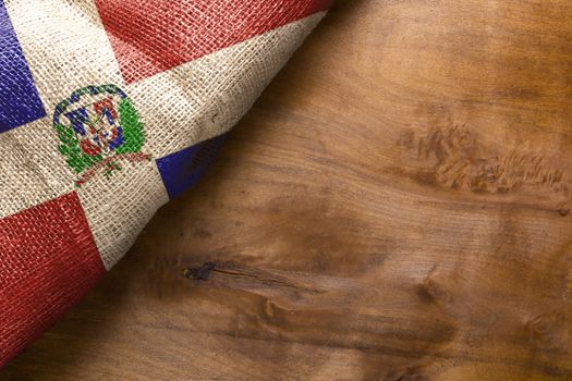 Flag of Dominican Republic state on a wooden background.