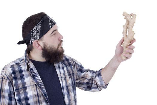 Bearded farmer with the root of ginger in the hands of