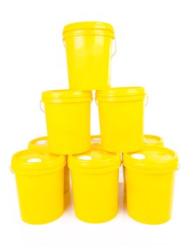 Yellow plastic bucket with yelllow lid. Product Packaging for lubricant, oil.Isolated over white background.