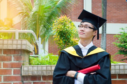 Confident asian university graduate