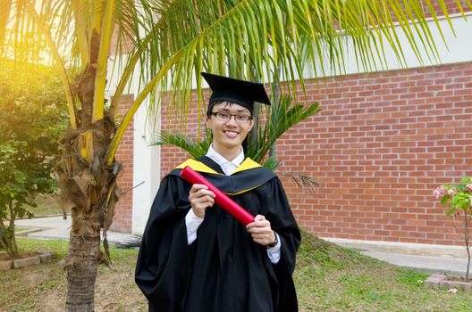 Cheerful asian university graduate