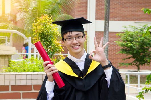 Cheerful asian university graduate