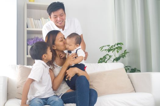 Asian family playing with baby