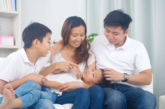 Asian family having fun at home