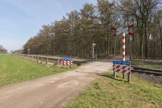 Unguarded, light rail railway crossing without barriers and warning lights in the East of the Netherlands
