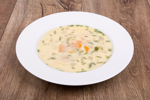 Vegetarian vegetable soup on a wooden table