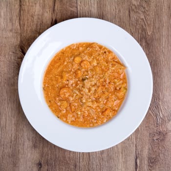 Vegetarian vegetable soup on a wooden table