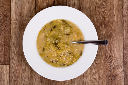 Vegetarian vegetable soup on a wooden table