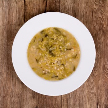 Vegetarian vegetable soup on a wooden table