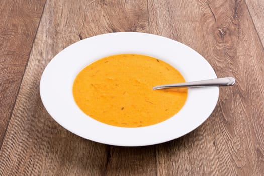 Vegetarian vegetable soup on a wooden table