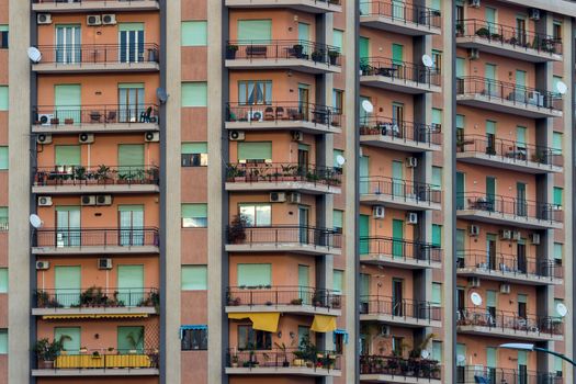 View of a facade of colored apartments with balconies