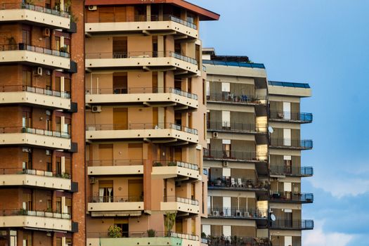 View of a facade of colored apartments with balconies