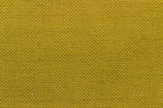 Rustic canvas fabric texture in mustard color.