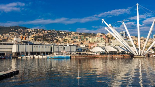 The Bigo is a 1992 building by Renzo Piano comissioned by the city and inspired from an ancient derrick for the ships servicing the old port of Genoa, Italy. Its longest arm (above the vantage point) lifts a cabin with tourist for a nice view over the city, while some others are supporting the roof of the Piazza del Feste (right).