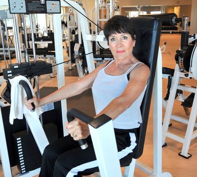 Female beauty working out inside a health club.