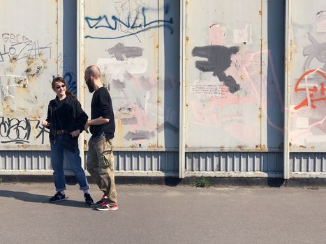 Kiev, Ukraine - April 04, 2017: Happy couple taking a picture on a wall background with graffiti