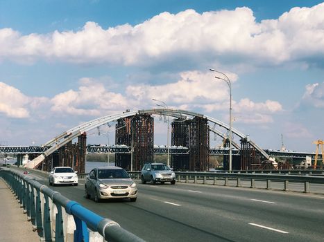 Kiev, Ukraine - April 04, 2017: Traffic in a big city on a bridge cityscape